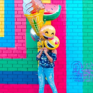 Girl holding colourful balloons