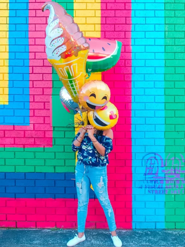 Girl holding colourful balloons